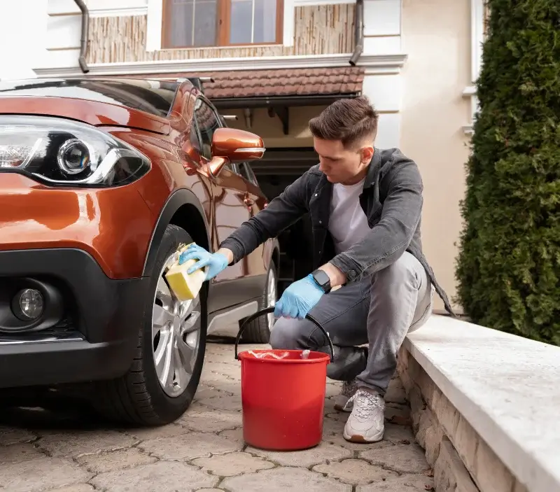 Lavage auto à domicile Rouffignac-Saint-Cernin-de-Reilhac : professionnel intervenant sur un véhicule